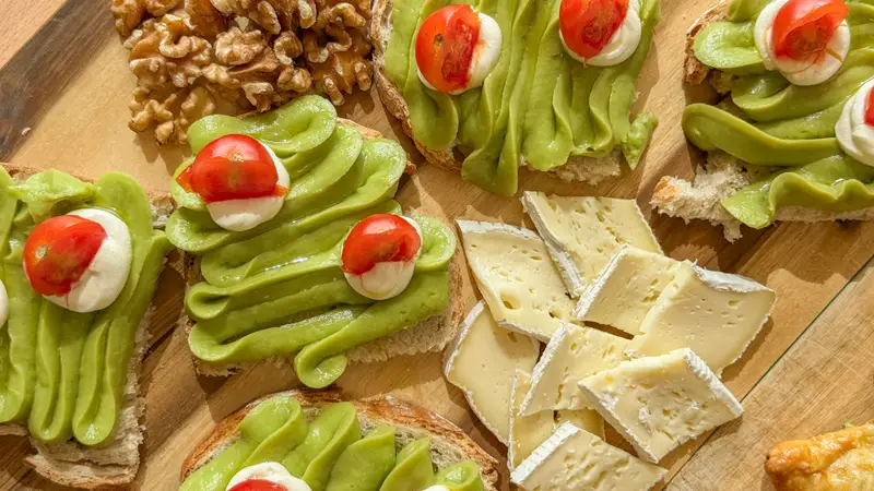 Assorted avocado, tomato and cheese toasts for corporate catering